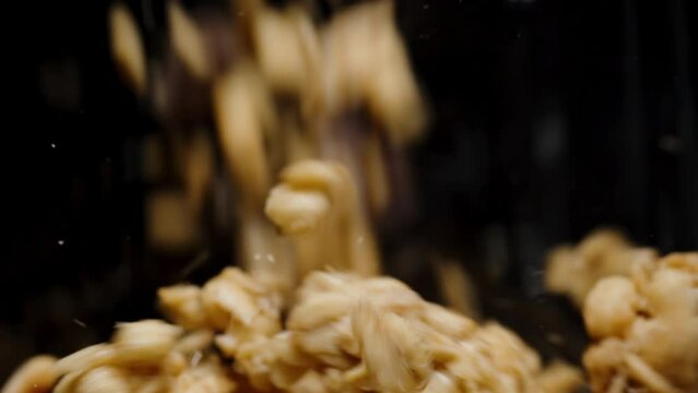 Useful breakfast of cereals, pouring granola into a jar, covering the entire frame, macro, slowed down.