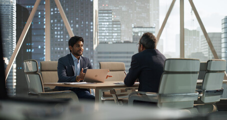 South Asians Business Partners Striking a Successful Deal at a Corporate Modern Meeting Room. Two...