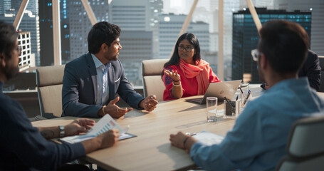 Indian Female Project Manager Makes a Business Presentation for a Diverse Creative Team in a...