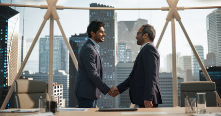 Two Young South Asian Businessmen Shaking Hands in a Corporate Office Conference Room. Operations Manager and Team Leader Discussing Creative Business Solutions for Their Company Project