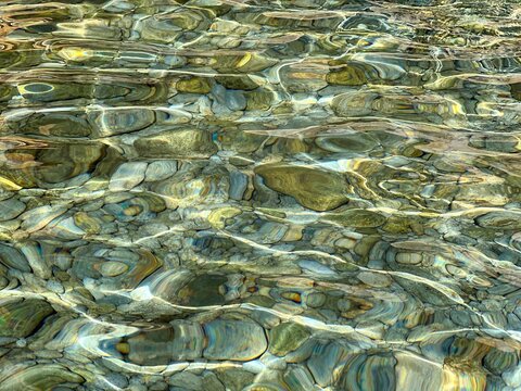 Underwater sea stones and pebbles in clear water.