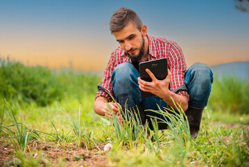 The farmer checks the fertility with digital analysis, reveals the secrets of the soil with...