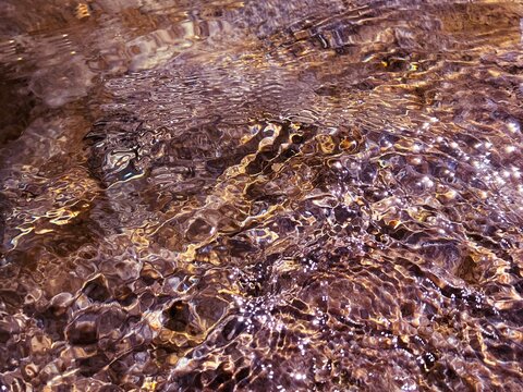 Underwater sea water with smooth pebbles stones in seabed.