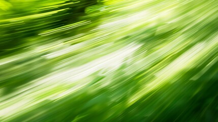Obraz premium Motion-blurred abstract background in green colors on a smooth texture. Colorful background blurred by speed in light green areas.