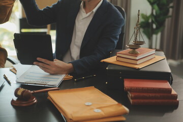 Justice and Law concept. Legal counsel presents to the client a signed contract with gavel and...