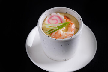 Japanese Traditional food Eggs Custard Chawanmushi isolated in black background
