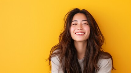 Naklejka premium Mixed race half-caucasian and half-japanese fashion model with long hair, raising one eyebrow with a big smile, thinking something, minimal yellow background.
