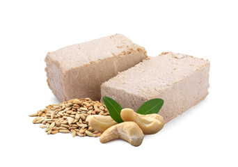 Tasty halva, peeled sunflower seeds, cashews and green leaves isolated on white