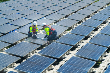 Photovoltaic engineers work on floating photovoltaics. workers Inspect and repair the solar panel equipment floating on water. Engineer working setup Floating solar panels Platform system on the lake.
