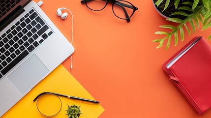 Top view of a laptop and earphones on a vibrant background, creating a visually striking and modern scene.