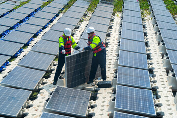 Photovoltaic engineers work on floating photovoltaics. workers Inspect and repair the solar panel equipment floating on water. Engineer working setup Floating solar panels Platform system on the lake.