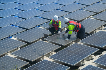 Photovoltaic engineers work on floating photovoltaics. workers Inspect and repair the solar panel equipment floating on water. Engineer working setup Floating solar panels Platform system on the lake.