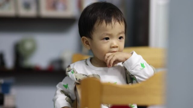 Portrait footage of Adorable and happy Chinese baby boy child on baby bed