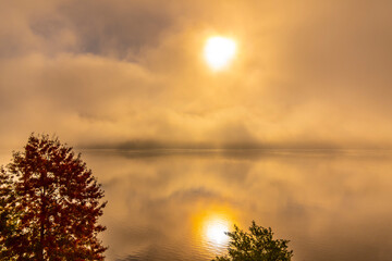 Obraz premium Cloudy Alpine Lake Lugano with Sunlight and Clouds on Surface Level in Lugano, Switzerland.