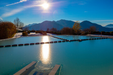 Swimming Pool with Ice and Mountain View and Sunlight in Lugano, Ticino in Switzerland.