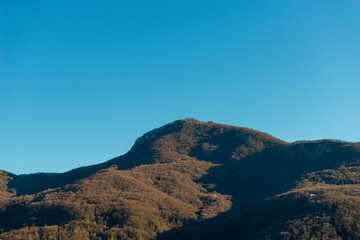 House on Mountain Peak with Clear Blue Sky in Ticino, Switzerland.