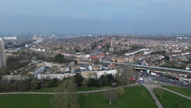London- Aerial view of London skyline showing train leaving Herne Hill Station and city and residential buildings in background