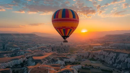 Deurstickers A hot air balloon ride at sunrise over the picturesque landscape of Cappadocia © MAY