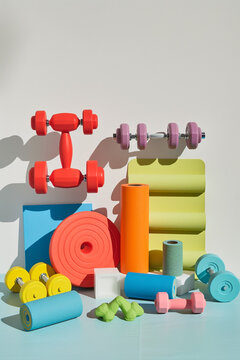 A creative display of fitness equipment like dumbbells and yoga mats, isolated on a white background to symbolize an active lifestyle