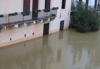 House near river at  after torrential rains due to climate change