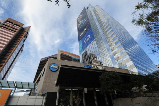 In downtown Phoenix, Arizona, a skyscraper displays an advertisement for Allstate Insurance Company on its windows, towering above a neighboring fitness center building
