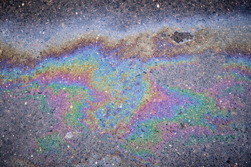 Textured Stain Emerges on Rain-Soaked Asphalt. Fuel or Oil Texture on Wet Asphalt.