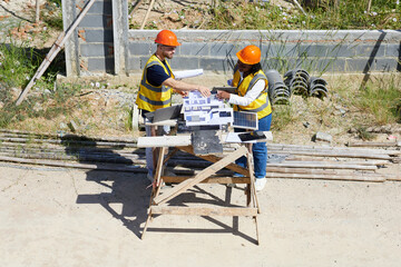 top view worker or architect working with house model at construction site