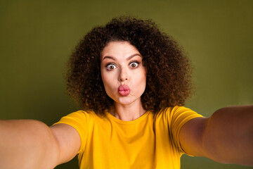 Selfie photo of young funky girl childish coquette woman wearing yellow t shirt plump lips kiss you...