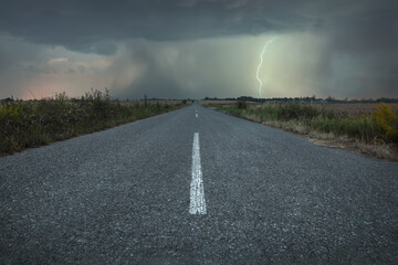 An empty road to meet the ominous summer storm