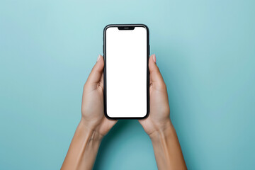 Female hands holding a smartphone against delicate pastel studio background
