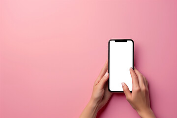 Fototapeta na wymiar Female hands holding a smartphone against delicate pastel studio background