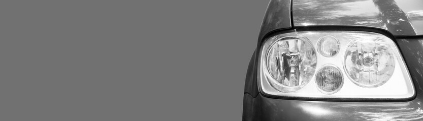 front headlight on a grey car. concept of selling auto parts	
