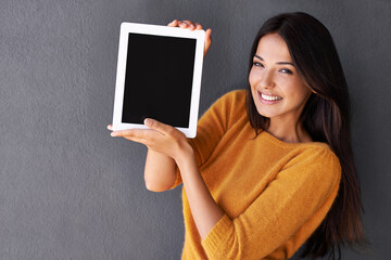Woman, portrait and tablet screen in studio, blank and mockup space for website or app. Female person, communication and empty display for marketing or advertising, social media and gray background