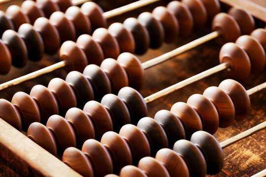 A vintage wooden abacus with beads and metal wire, perfect for counting