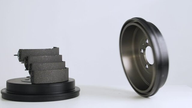 
Brake disc spinning slowly on a white background. Automotive parts. Advertising
