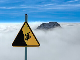 Sign for danger at the edge of a cliff