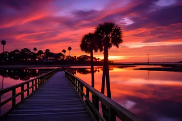 Selbstklebende Fototapeten Majestic Dawn: Sunrise Reflecting on Tranquil Beach with Silent Palm Trees and Wooden Boardwalk © Joe