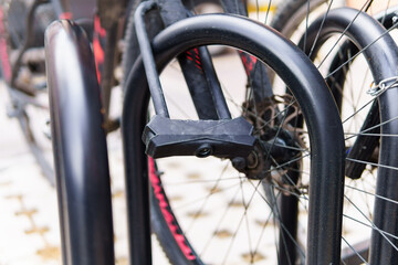 a bicycle tied with a U-type lock in a bicycle parking