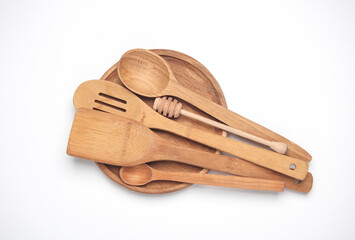 Wooden kitchen utensils on a white background.