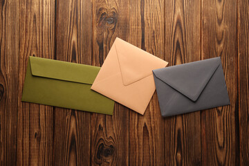 Colored envelopes on a wooden table. Top view