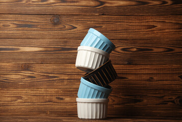 Ceramic bowls on wooden background close up