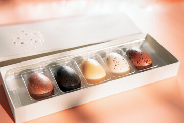 A box of chocolate eggs with the inscription in English Happy Easter. Easter concept. 