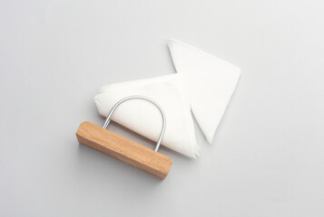 Wooden napkin holder with napkins on a white background
