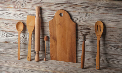 Set of wooden eco kitchen utensils on boards.