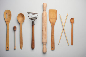 Set of wooden eco kitchen utensils on white background. Flat lay. Top view - obrazy, fototapety, plakaty