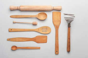 Set of wooden eco kitchen utensils on white background. Flat lay. Top view