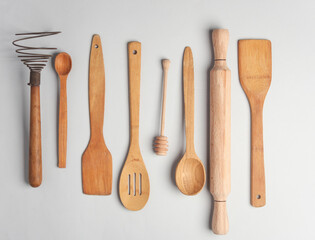 Set of wooden eco kitchen utensils on white background. Flat lay. Top view