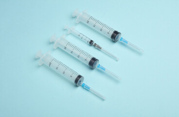 Syringes on a blue background. Medicine concept