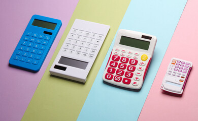 Different calculators on colored pastel background