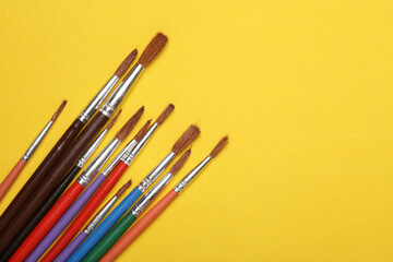 Set of brushes for painting on yellow background